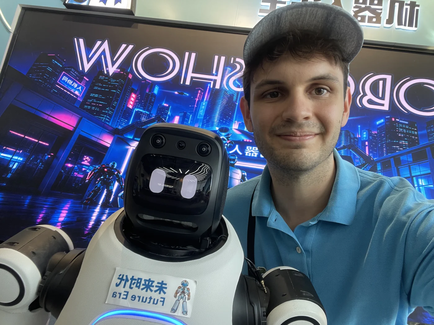 Nicolò Campagnoli standing beside a robot
